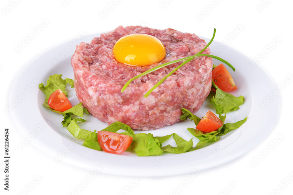 Delicious steak tartare with yolk on plate isolated on white Delicious steak tartare with yolk on plate isolated on white