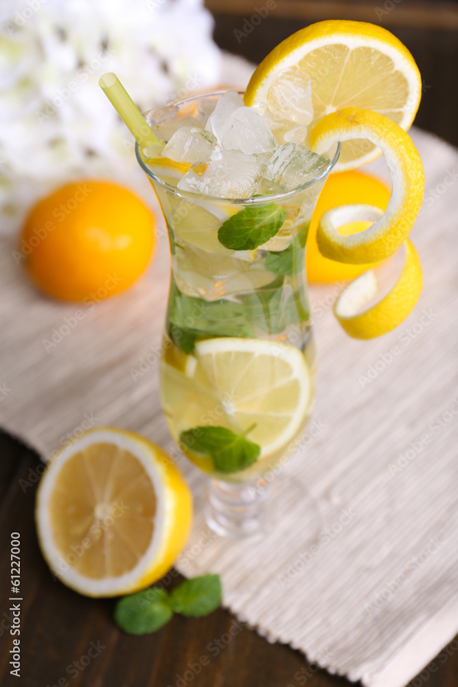 Glass of cocktail with lemon and mint on table close-up Glass of cocktail with lemon and mint on table close-up