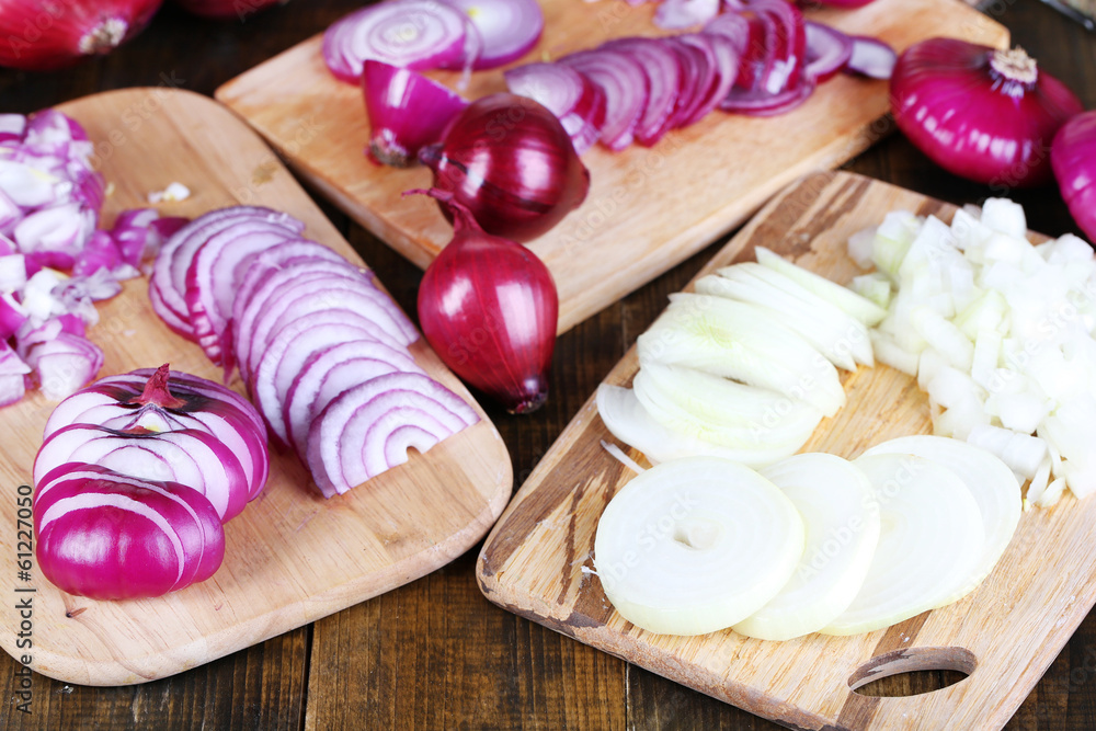 Cut onion on cutting board on wooden background
