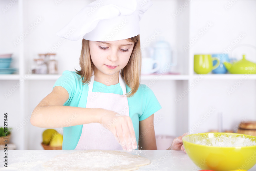 Little girl preparing cake dough in kitchen at home Little girl preparing cake dough in kitchen at home