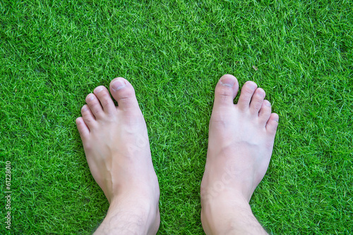 Feet over green grass