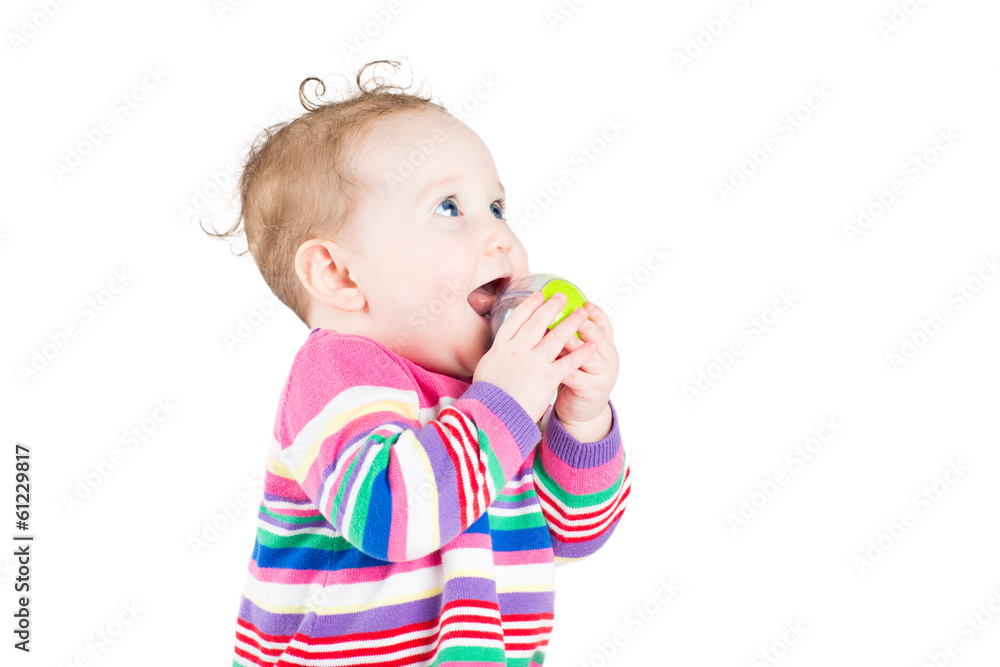 Cute curly baby girl playing with a ball, isolated on white Cute curly baby girl playing with a ball, isolated on white