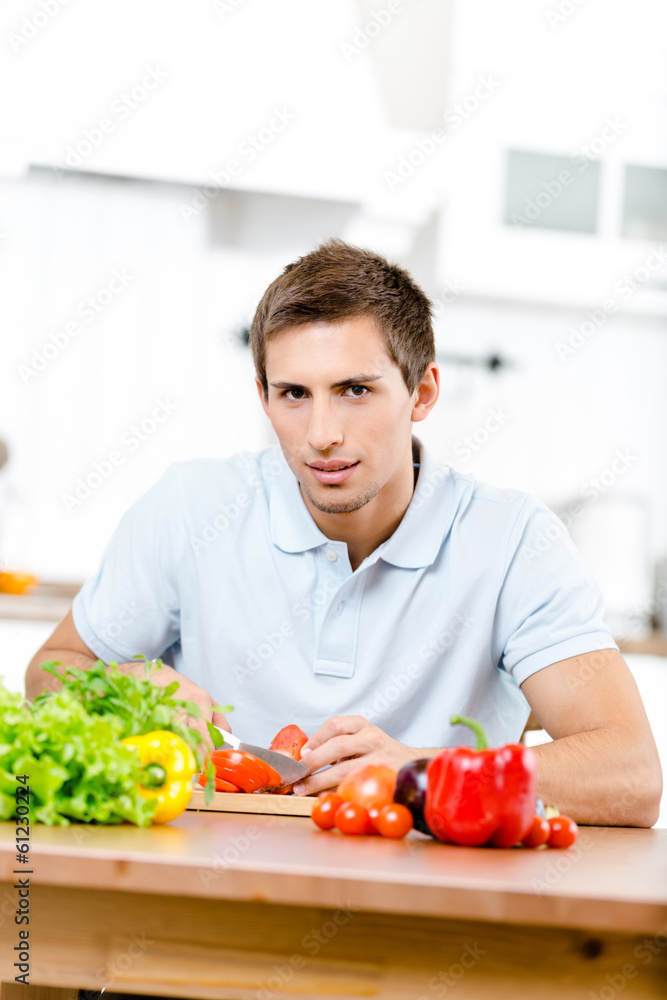 Man slicing vegetables for breakfast Man slicing vegetables for breakfast