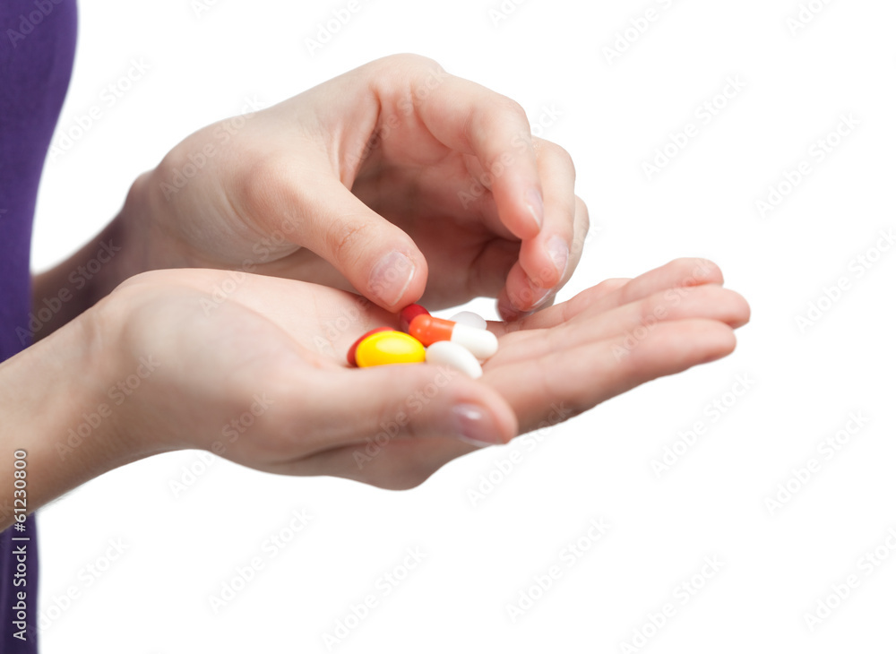 Pills on the hand. Herbal remedy, isolated on white Pills on the hand. Herbal remedy, isolated on white