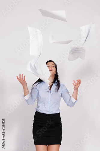 Woman throws out paper into the air