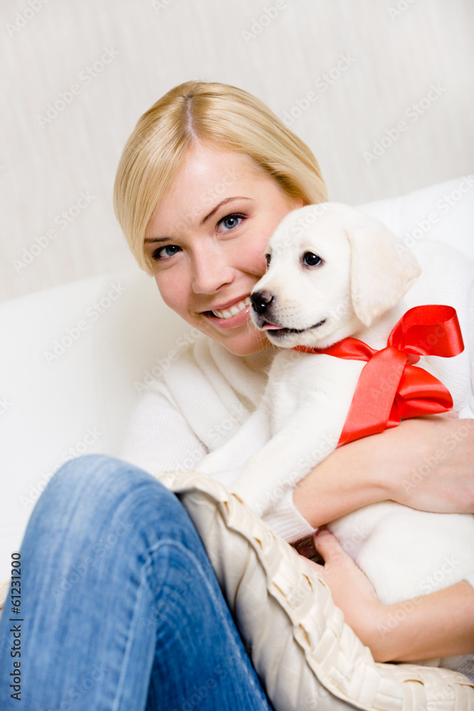 Woman embracing white puppy of Labrador Woman embracing white puppy of Labrador
