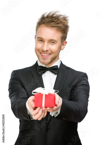 Half-length portrait of businessman handing gift box