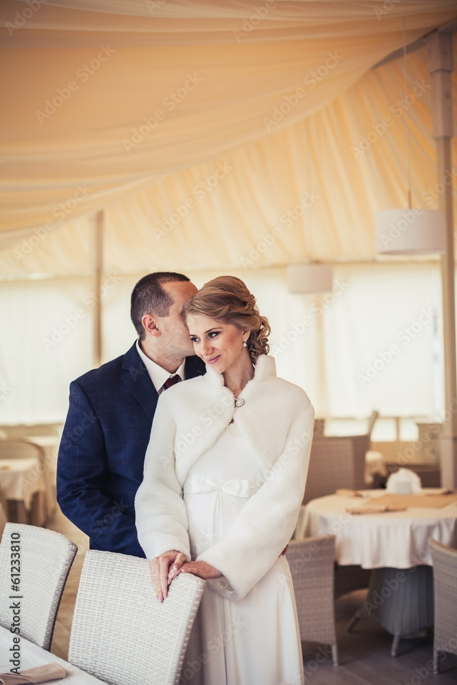 wedding. newlyweds sitting in a cozy cafe in beige scenery wedding. newlyweds sitting in a cozy cafe in beige scenery