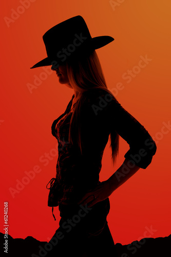 Obraz na płótnie Silhouette of cowgirl with hands on her hips