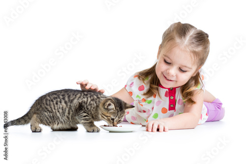 cute kid girl feeding kitten