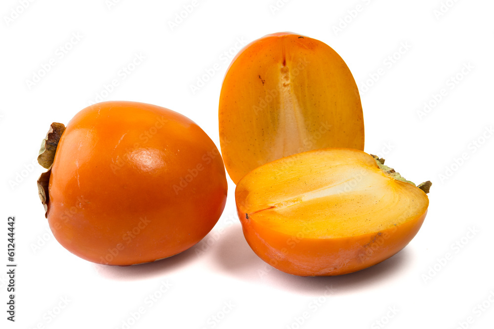 Persimmons, one whole and one cut in two pieces