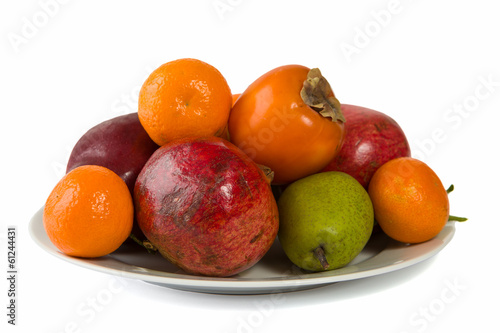 Plate full of fruits isolated on white