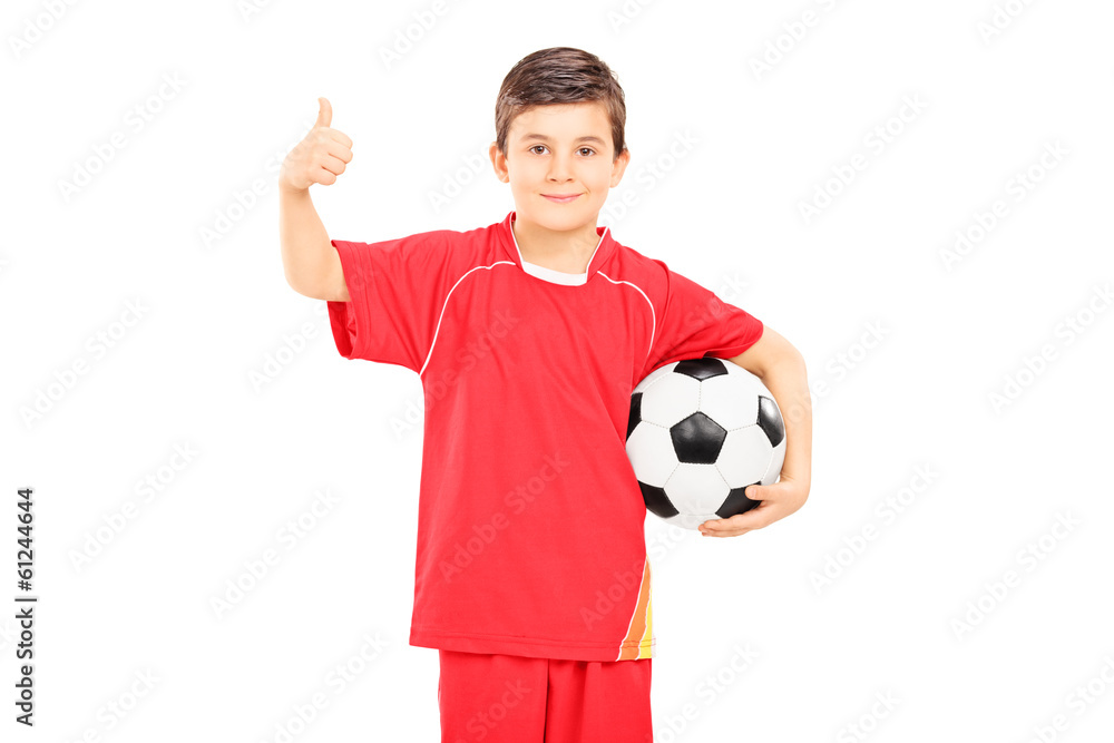 Boy in sportswear holding a football and giving thumb up