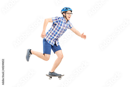 Young man with helmet riding a small skateboard
