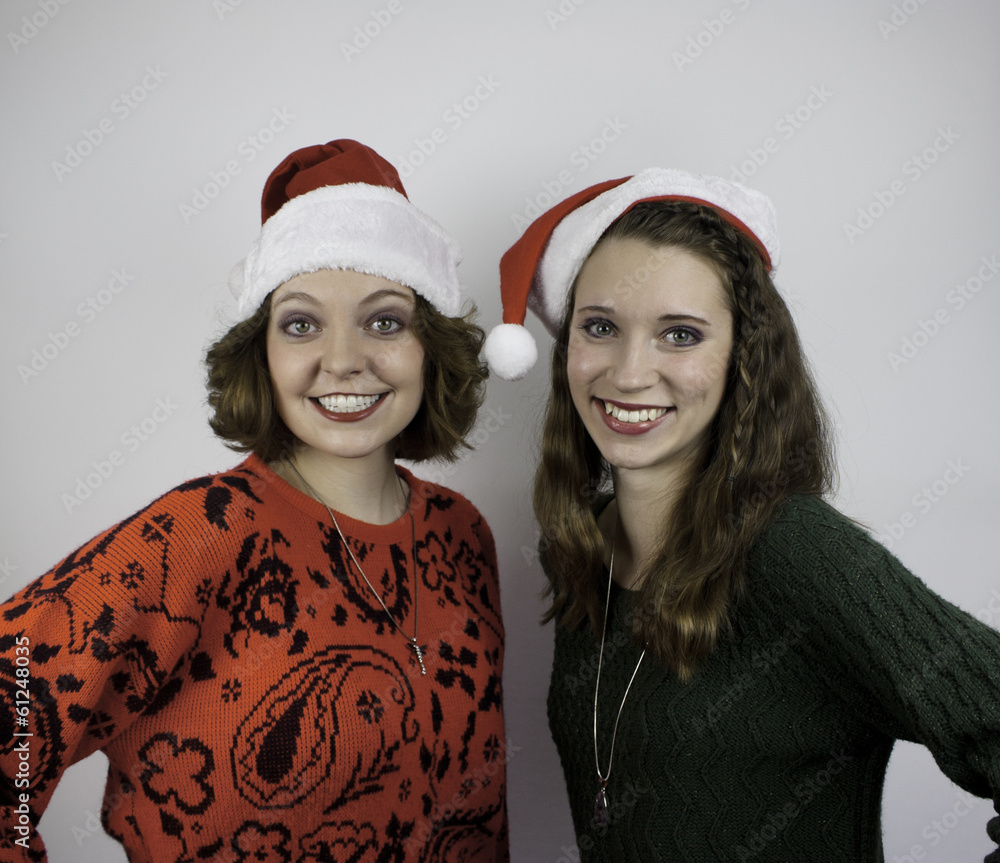 Two attractive women wearing Santa hats Two attractive women wearing Santa hats