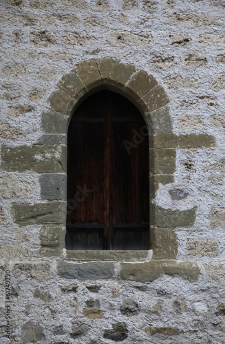 Arch window in old stone wall of medieval castle