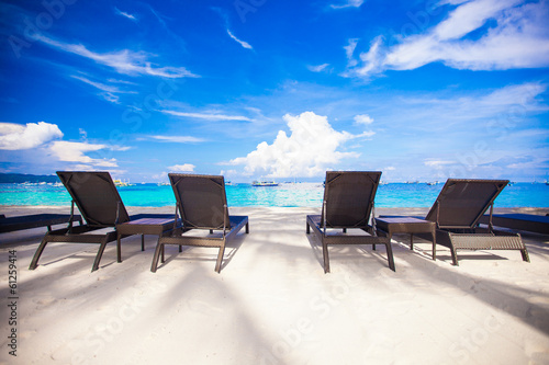 Beach chairs in exotic resort on perfect white sandy beach © travnikovstudio
