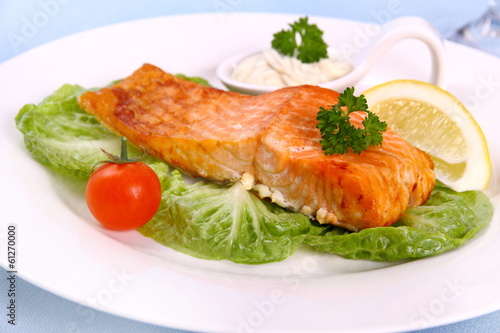Grilled salmon fillet with salad and lemon