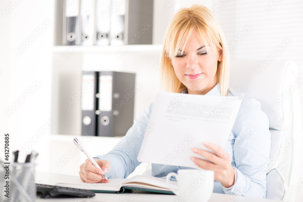 Businesswoman sitting at the table in the office. Businesswoman sitting at the table in the office.