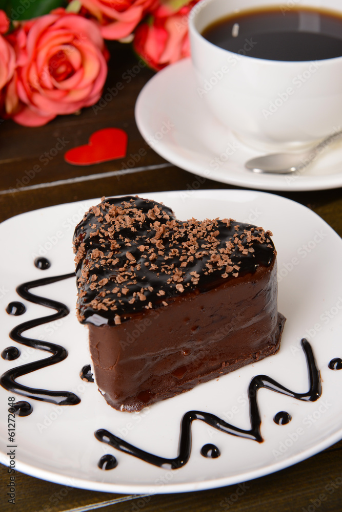 Sweet cake with chocolate on plate on table close-up Sweet cake with chocolate on plate on table close-up