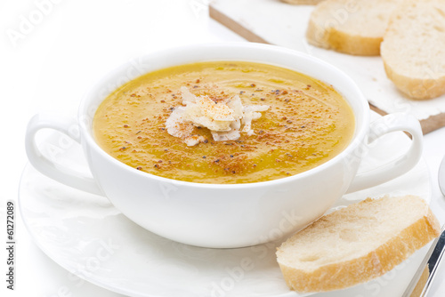 cream soup of yellow lentils with bread, close-up, isolated