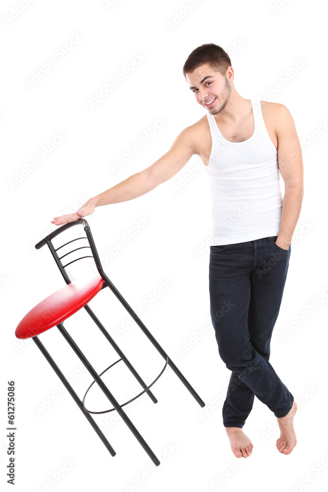 Handsome young man with chair isolated on white