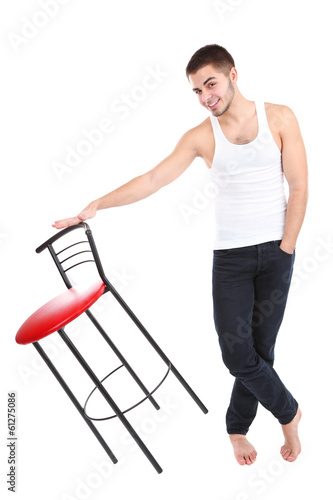 Handsome young man with chair isolated on white © Africa Studio