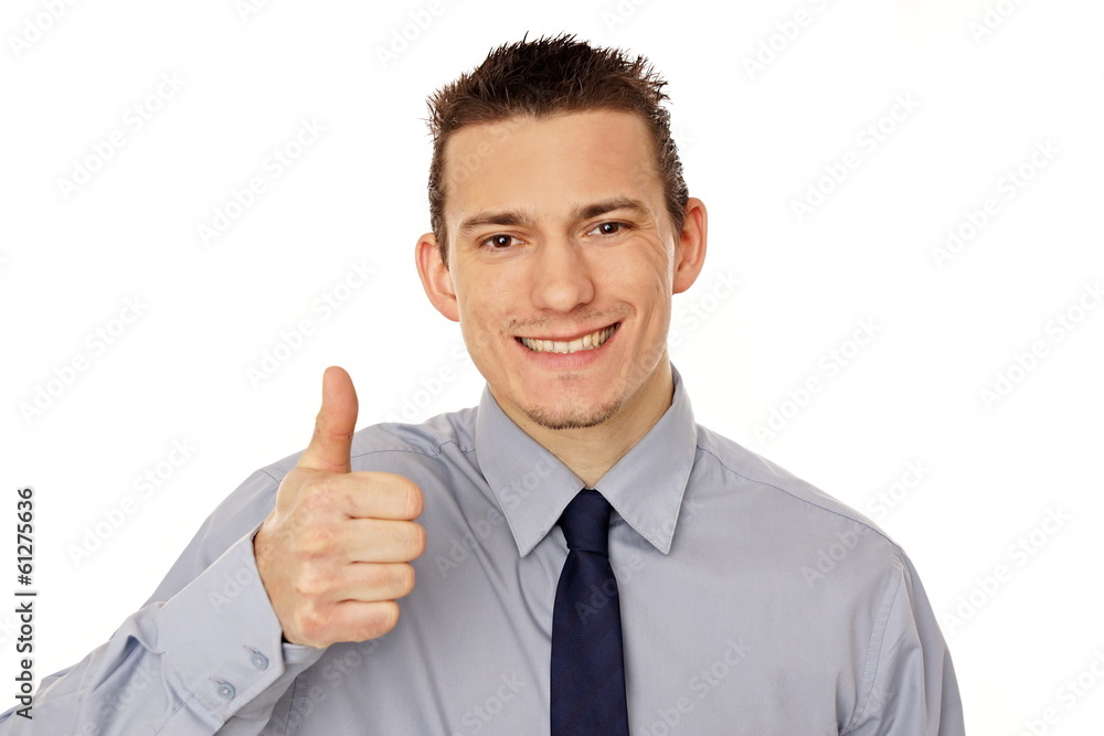 Young smiling businessman showing thumb up Young smiling businessman showing thumb up