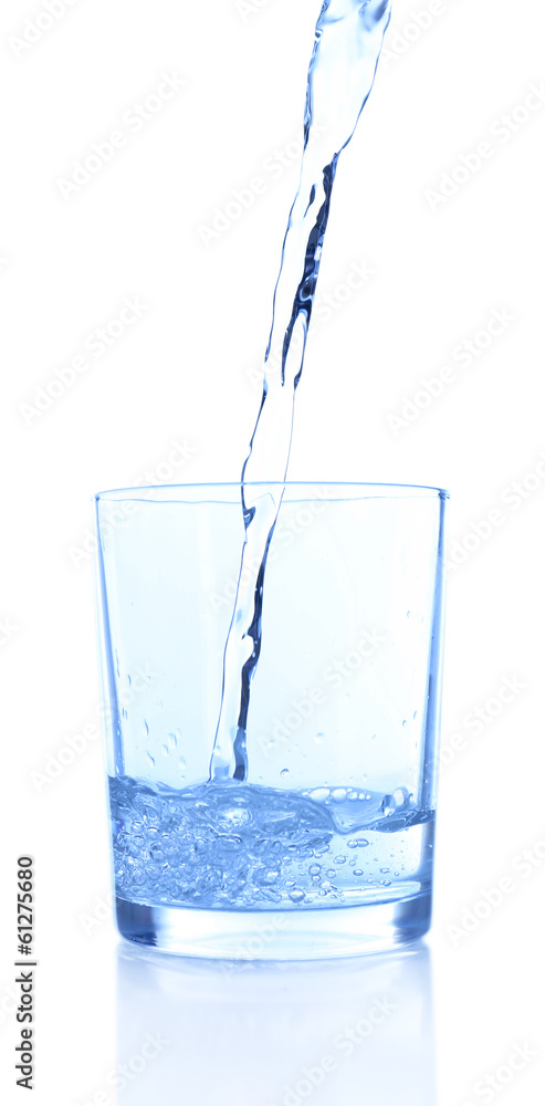 Pouring water into glass on blue background Pouring water into glass on blue background