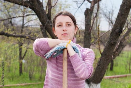 Young woman with onion at garden - Garden works