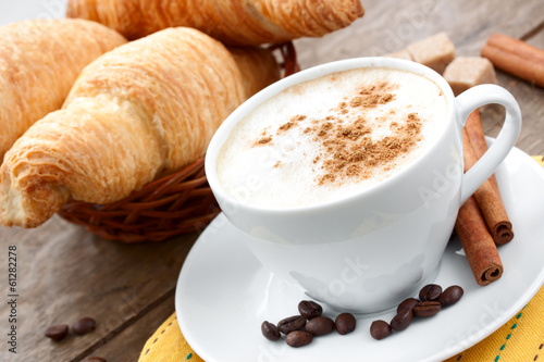 Fototapeta Naklejka Na Ścianę i Meble -  сup of coffee cappuccino  and croissants in a background