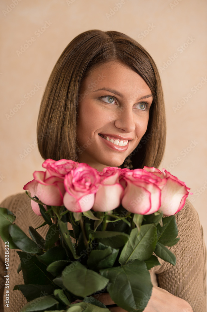 Pretty brunette woman holding bunch of roses Pretty brunette woman holding bunch of roses