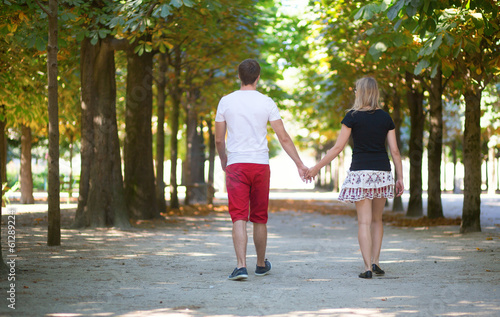 Couple walking in the Tuileries garden of Paris