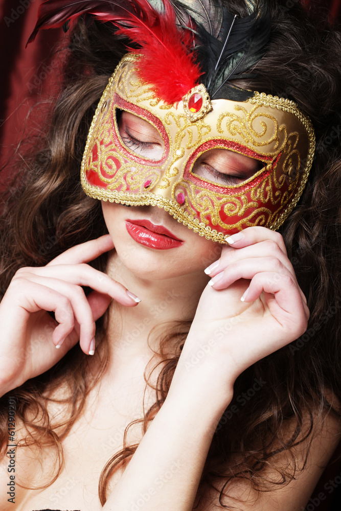 young woman in a red mysterious mask young woman in a red mysterious mask
