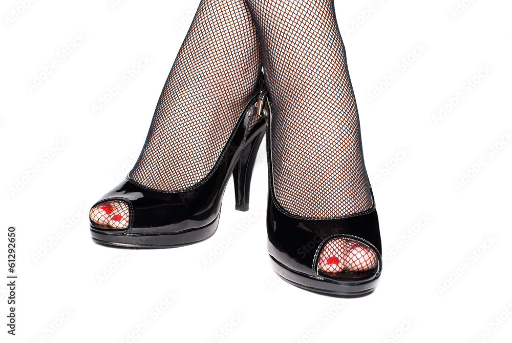 Female legs in black shoes isolated