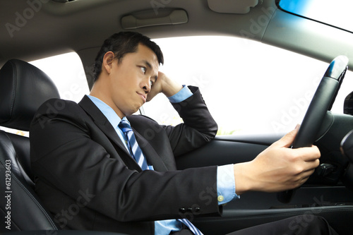 depressed businessman holding head and driving car © Tom Wang