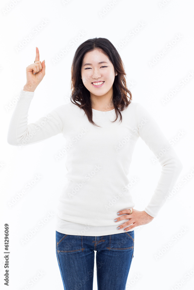 Smiling young woman pointing upwards Smiling young woman pointing upwards
