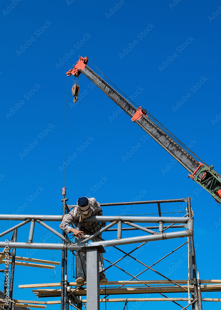 Workers welding steel structures with hight area