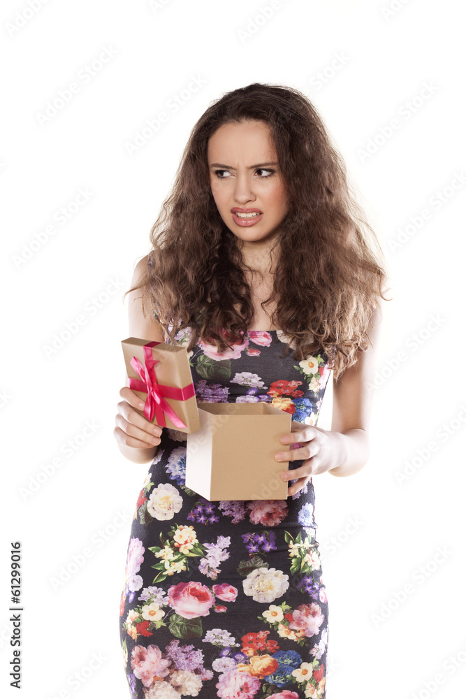 unhappy girl opens a gift that is not satisfied unhappy girl opens a gift that is not satisfied