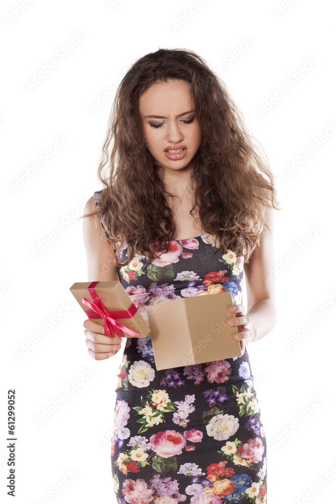 unhappy girl opens a gift that is not satisfied