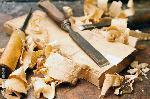 old wood chisels with shavings on the workbench