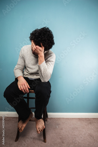 Sad man sitting on a chair