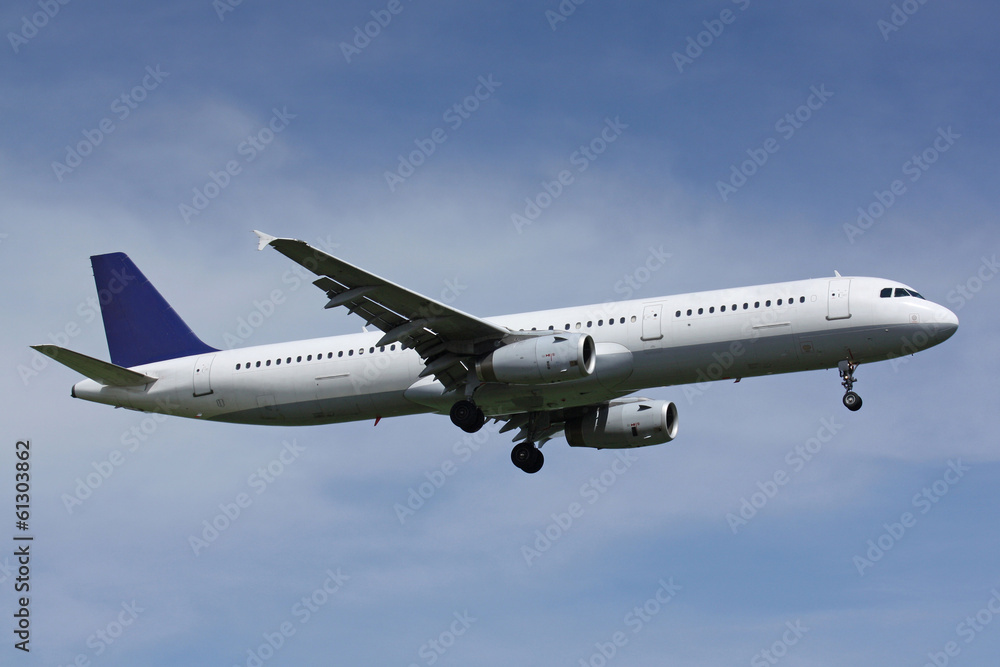 White plane with blue tail landing in sunny day White plane with blue tail landing in sunny day