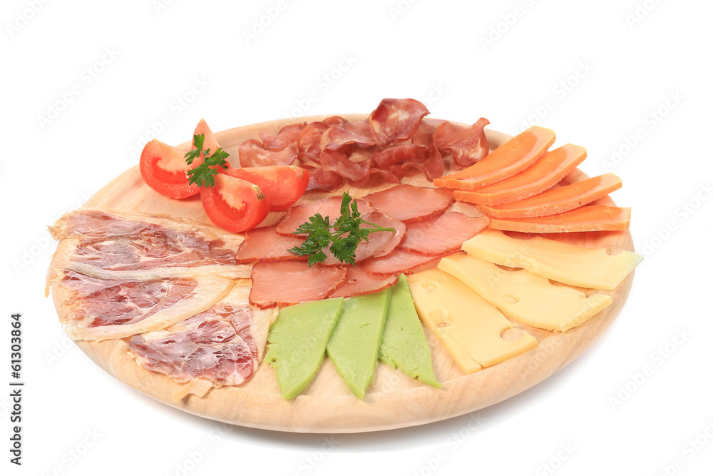 Various cheese on wooden platter.