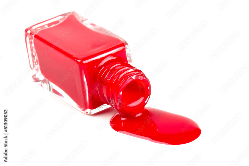 red polish bottle spilled over white background red polish bottle spilled over white background