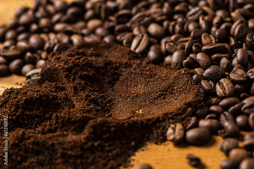 Coffee beans over wooden surface