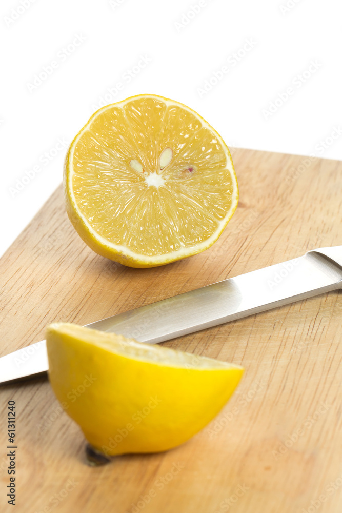 Lemon over chopping board Lemon over chopping board