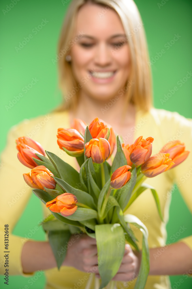 Orange spring tulips woman in background