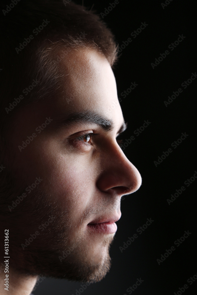 Fototapeta premium Handsome young man on dark background