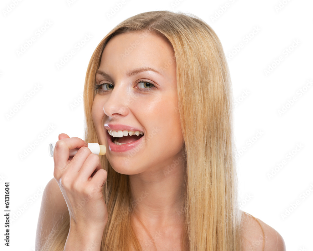 Young woman using hygienic lipstick Young woman using hygienic lipstick